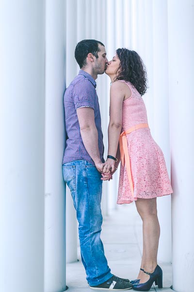 lovers kissing between white columns