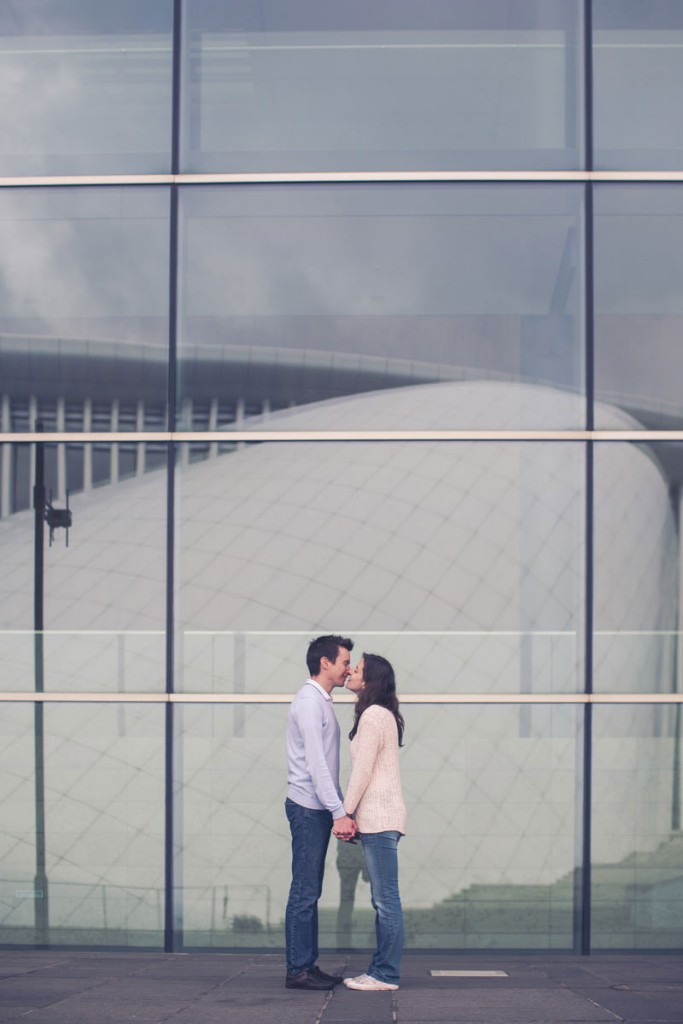 the photographer shot the reflection of the building in front of couple