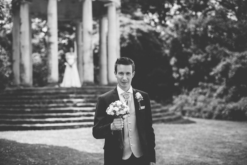 groom holding the bouquet and waiting for his bride