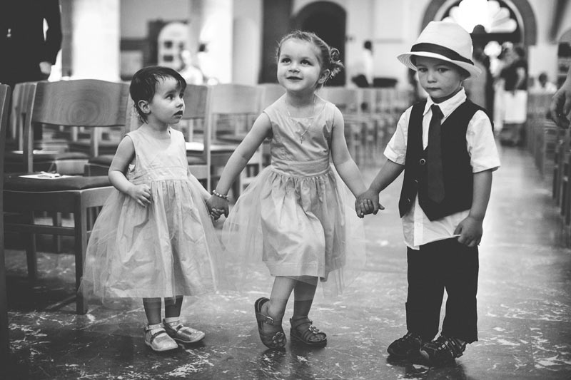 children holding hands during the wedding ceremony in church
