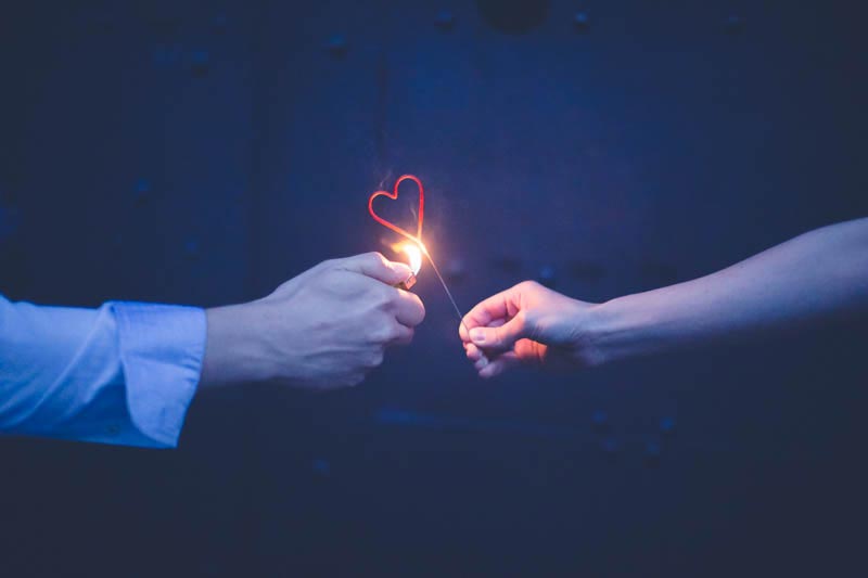 heart-shaped candle lit up during an engagement session