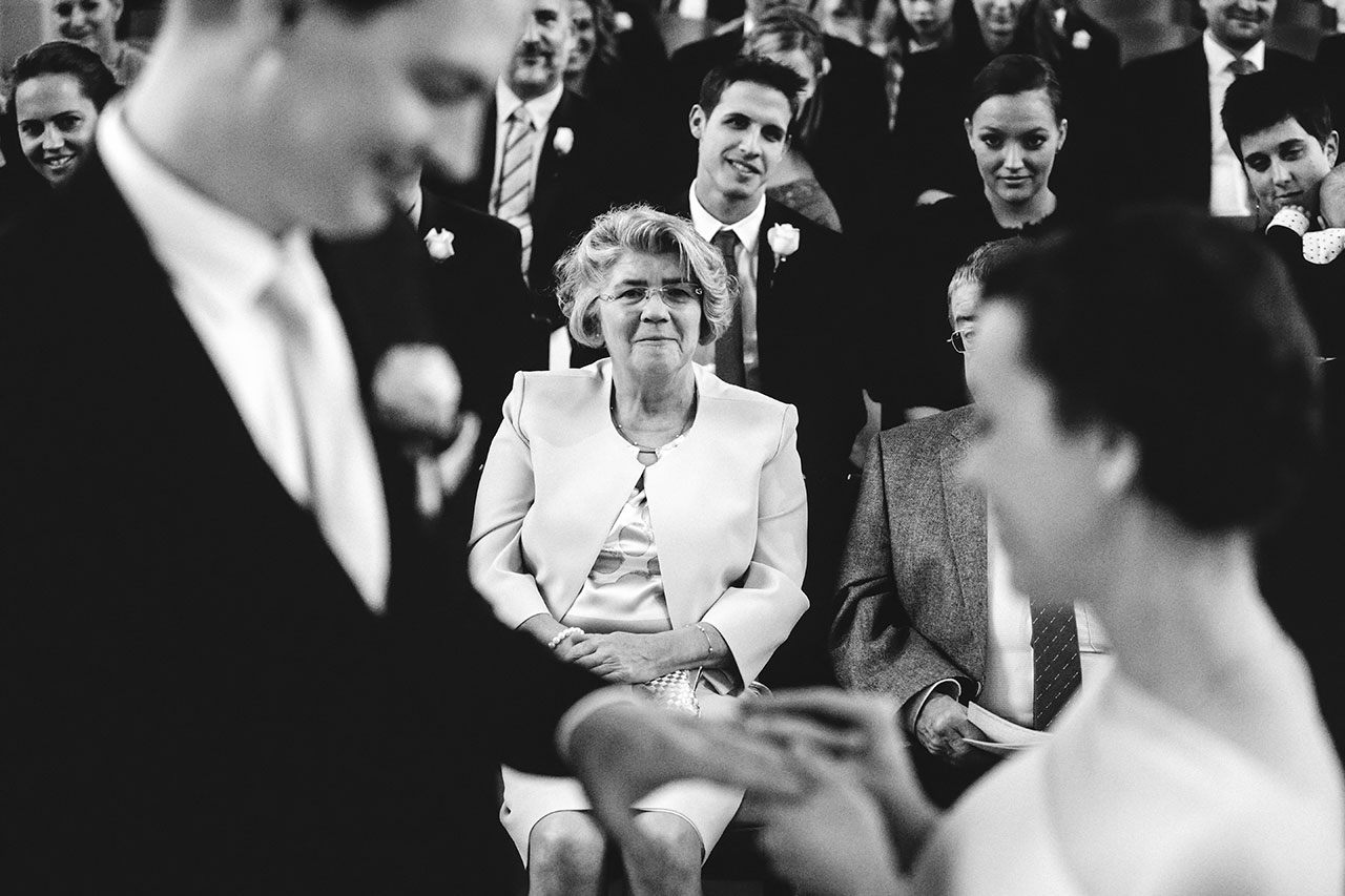 exchanging wedding rings in front of guest