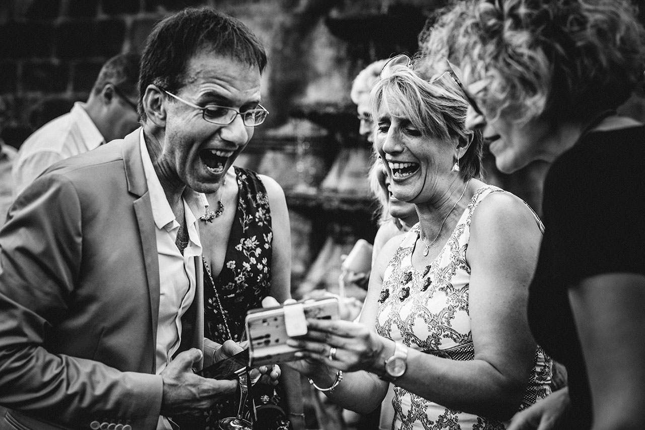 people laughing out loud at wedding reception