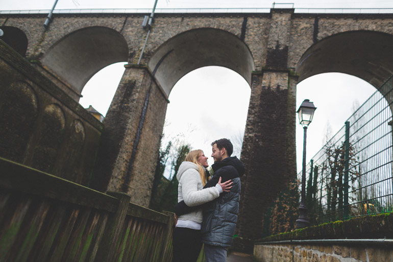 a great shot of bridal couple under a bridge of luxembourg