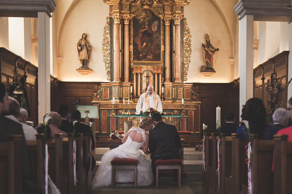 bride and groom in front of priest at hesperange church