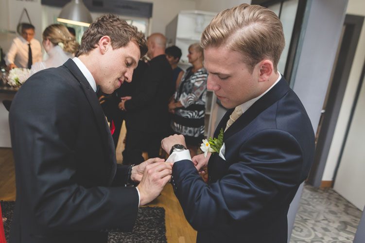 bestman helping groom with cufflinks
