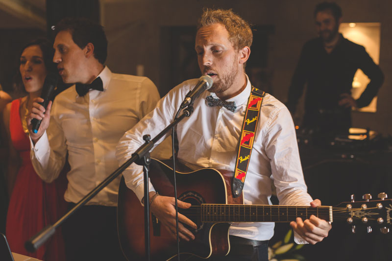guest playing guitar at wedding party