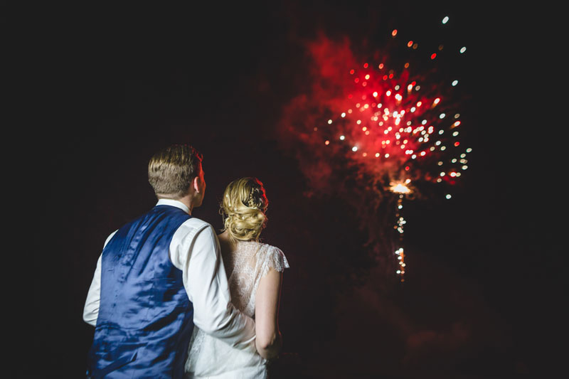 bride and groom watching fireworks during french wedding