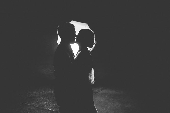 silhouette of bride and groom kissing