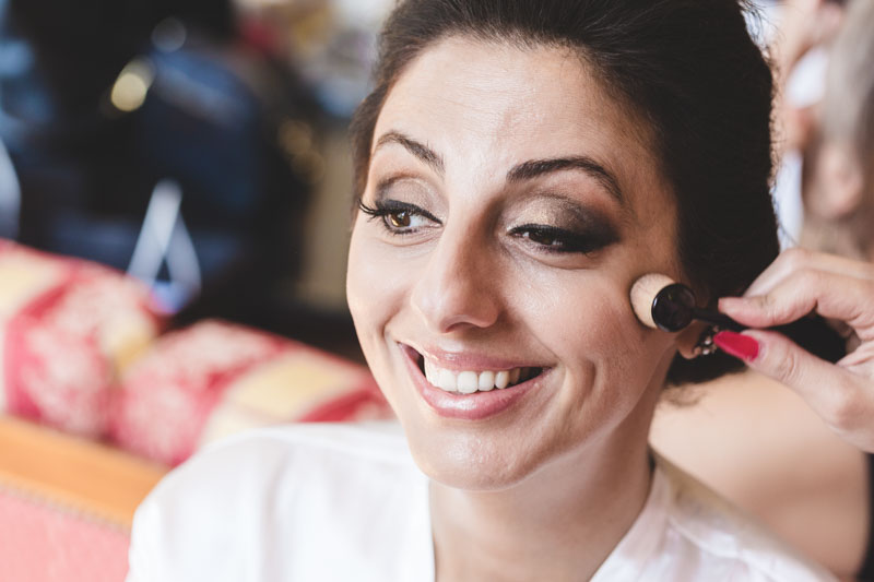 smile of a woman getting make up