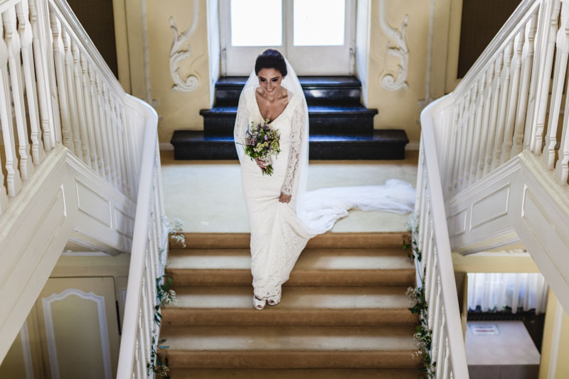 the bride walks down the stairs