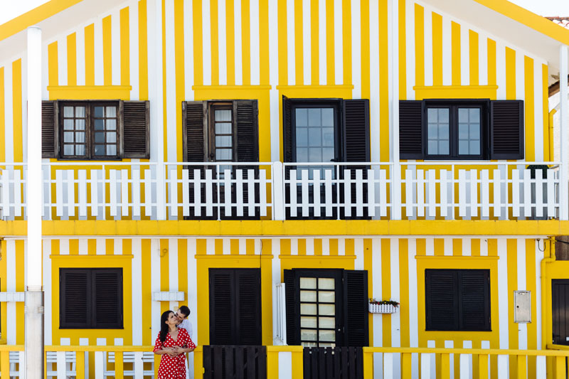 couple in front of yellow house in Aveiro Portugal