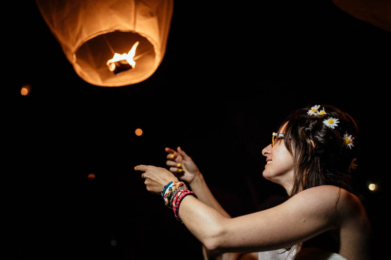 bride let go a paper lantern in the sky