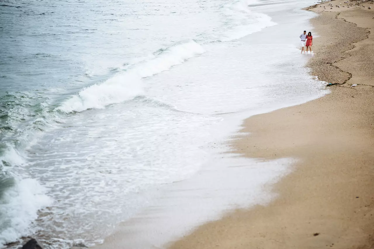 lovers walking on the beach near Porto